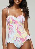 Woman wearing a colorful swimsuit on a gray background